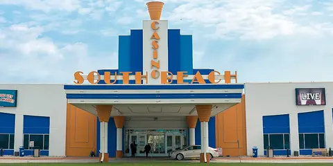 The front of South Beach Casino & Resort with its blue and orange facade and the hotel wing